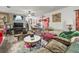 Cozy living room with decorative art, plush seating, and a ceiling fan at 14422 Scottburgh Glen Dr, Wimauma, FL 33598
