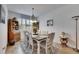 Charming dining room featuring a wooden table, vintage hutch, and decorative rug over ceramic tile flooring at 15657 Aurora Lake Cir, Wimauma, FL 33598