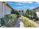 Charming front entrance with paver walkway, landscaping, and welcoming nautical decor at 15657 Aurora Lake Cir, Wimauma, FL 33598