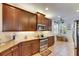 Kitchen with granite countertops, stainless steel appliances, tile backsplash, and wooden cabinets at 15657 Aurora Lake Cir, Wimauma, FL 33598