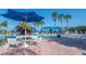 Community pool with a seating area, perfect for enjoying the sunshine and scenery at 15657 Aurora Lake Cir, Wimauma, FL 33598