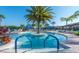 Community pool with beautiful palm trees with a clear view and entry for those with mobility issues at 15657 Aurora Lake Cir, Wimauma, FL 33598