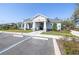 Exterior of a community clubhouse featuring a welcoming entrance, professional landscaping, and accessible parking at 1567 Flower Dust Dr, Ruskin, FL 33570