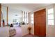 Inviting foyer with a paneled front door opens to a living room with a retro decor at 1830 Oak Forest S Dr, Clearwater, FL 33759