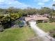 A charming single-Gathering home with a screened pool, a well-manicured lawn, and a two-car garage at 1830 Oak Forest S Dr, Clearwater, FL 33759