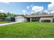 A delightful single-Gathering home boasts a well-kept lawn, mature shrubs, and a two-car garage at 1830 Oak Forest S Dr, Clearwater, FL 33759