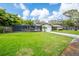 Well-manicured lawn with palm trees and a view of the home's exterior at 1830 Oak Forest S Dr, Clearwater, FL 33759