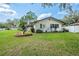 A charming home is complemented by its manicured front yard and decorative landscaping at 1830 Oak Forest S Dr, Clearwater, FL 33759