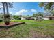 Charming single-story home with a lush front yard, mature trees, and attractive landscaping at 1830 Oak Forest S Dr, Clearwater, FL 33759