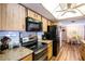 Updated kitchen with stainless steel appliances, granite countertops, and wood-look floors at 1830 Oak Forest S Dr, Clearwater, FL 33759