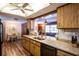 Open kitchen layout featuring stainless steel appliances, granite counters, and hardwood floors at 1830 Oak Forest S Dr, Clearwater, FL 33759