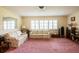 Spacious living room with plantation shutters, comfortable seating, and classic interior details at 1830 Oak Forest S Dr, Clearwater, FL 33759