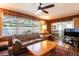 Cozy living room area featuring a large window and wood paneled walls at 1830 Oak Forest S Dr, Clearwater, FL 33759