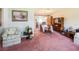 Inviting living room showcasing cozy furniture, floral wallpaper accent, and dining space beyond at 1830 Oak Forest S Dr, Clearwater, FL 33759