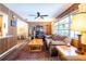 Cozy living room featuring a large window, wood paneling and lots of natural light at 1830 Oak Forest S Dr, Clearwater, FL 33759