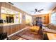 Open concept living space adjacent to the kitchen and dining area with wood paneling at 1830 Oak Forest S Dr, Clearwater, FL 33759