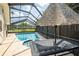 Screened-in pool with patio furniture and a view of the neighborhood at 1830 Oak Forest S Dr, Clearwater, FL 33759