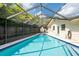 Spacious screened-in pool with spa and seating area, perfect for Florida outdoor living at 1830 Oak Forest S Dr, Clearwater, FL 33759