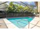 Large screened-in pool with a built-in spa offers a relaxing outdoor experience at 1830 Oak Forest S Dr, Clearwater, FL 33759