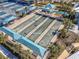 Aerial view of the community bocce ball courts, showcasing covered seating areas and lush landscaping at 18955 Sailors Delight Pass, Land O Lakes, FL 34638