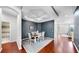 Dining room features hardwood floors, tray ceiling, modern decor, and access to adjacent rooms at 203 Oceania Ct, Apollo Beach, FL 33572