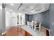 Dining room features hardwood floors, tray ceiling, modern decor, and access to adjacent rooms at 203 Oceania Ct, Apollo Beach, FL 33572