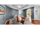 Dining room features hardwood floors, tray ceiling, modern decor, and access to the kitchen at 203 Oceania Ct, Apollo Beach, FL 33572