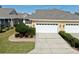 Inviting single-story home with a well-maintained front yard and a two-car garage at 203 Oceania Ct, Apollo Beach, FL 33572