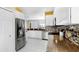 Bright kitchen features white cabinetry, mosaic backsplash, stainless appliances, and granite countertops at 203 Oceania Ct, Apollo Beach, FL 33572