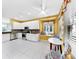 Bright eat-in kitchen features white cabinetry, mosaic backsplash, stainless appliances, and a breakfast table at 203 Oceania Ct, Apollo Beach, FL 33572