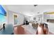 Bright living room features hardwood floors, stylish furniture and a large screen TV at 203 Oceania Ct, Apollo Beach, FL 33572
