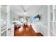 Bright living room area boasts hardwood floors, ceiling fan and large flat screen television at 203 Oceania Ct, Apollo Beach, FL 33572