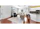 Cozy living room with a view of the kitchen, lots of natural light, and stylish decor at 203 Oceania Ct, Apollo Beach, FL 33572