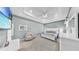 Large main bedroom featuring tray ceiling, neutral colors, and flat screen television at 203 Oceania Ct, Apollo Beach, FL 33572