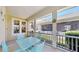 Cozy screened porch featuring a dining table with seating and views of the beautifully landscaped community at 203 Oceania Ct, Apollo Beach, FL 33572
