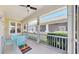 Spacious screened-in porch with dining set and colorful rug, perfect for outdoor entertaining and relaxation at 203 Oceania Ct, Apollo Beach, FL 33572