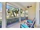 Comfortable screened porch featuring wicker chairs and ceiling fan with views of the landscaped yard and neighborhood at 203 Oceania Ct, Apollo Beach, FL 33572