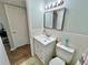 Bathroom with vanity, toilet, and a door leading to another room at 2226 Switzerland Way # 32, Clearwater, FL 33763