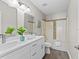 Modern bathroom featuring dual sinks, updated fixtures, and a shower-tub combo at 2442 Silvermoss Dr, Wesley Chapel, FL 33544