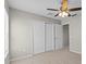 A comfortable bedroom featuring neutral carpeting, a ceiling fan, and double door closet at 2442 Silvermoss Dr, Wesley Chapel, FL 33544