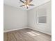 Minimalist bedroom with hardwood flooring and a window at 2442 Silvermoss Dr, Wesley Chapel, FL 33544