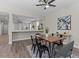 Dining room with wood table, black chairs, blue/gray rug, and decor at 2442 Silvermoss Dr, Wesley Chapel, FL 33544