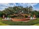 Beautifully landscaped community entrance sign with brick and floral design at 2442 Silvermoss Dr, Wesley Chapel, FL 33544