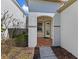 Welcoming front entrance with a tiled foyer and modern door, perfect for greeting guests at 2442 Silvermoss Dr, Wesley Chapel, FL 33544