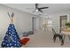 Bright hallway featuring neutral walls, ceiling fan, a cozy play area, and access to the staircase and other rooms at 2442 Silvermoss Dr, Wesley Chapel, FL 33544