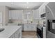 Bright kitchen with white cabinets, stainless steel appliances, and quartz countertops at 2442 Silvermoss Dr, Wesley Chapel, FL 33544