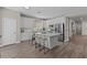 Open concept kitchen with white cabinets, stainless steel appliances, and quartz countertops at 2442 Silvermoss Dr, Wesley Chapel, FL 33544