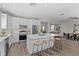 Spacious kitchen with stainless appliances, white cabinets, island, and eat-in dining at 2442 Silvermoss Dr, Wesley Chapel, FL 33544