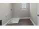 A functional laundry room features durable flooring, and essential utility connections at 2442 Silvermoss Dr, Wesley Chapel, FL 33544