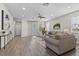 Open-concept living area with hardwood floors and access to the outdoor patio at 2442 Silvermoss Dr, Wesley Chapel, FL 33544